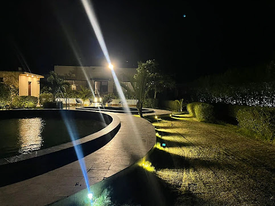 Pools and lawns glowing with lights at night