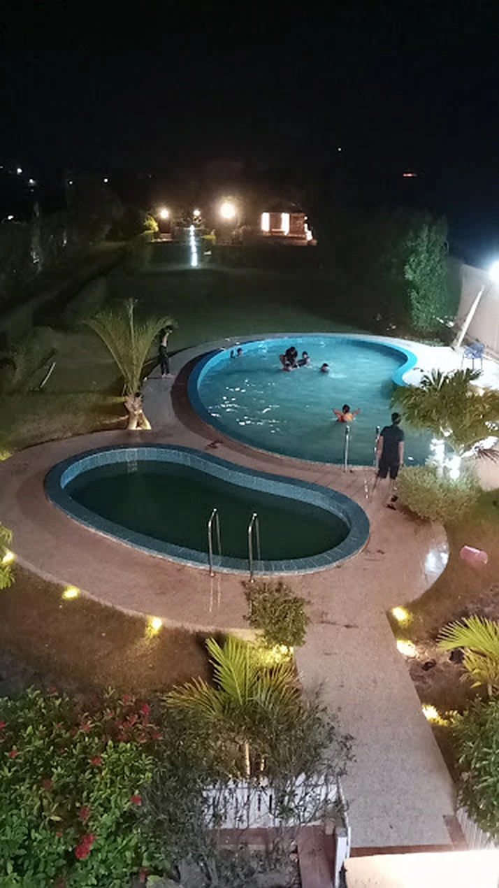 Night swim in the illuminated twin pools