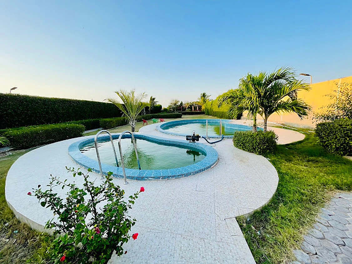 Adult and kids swimming pools surrounded by palms