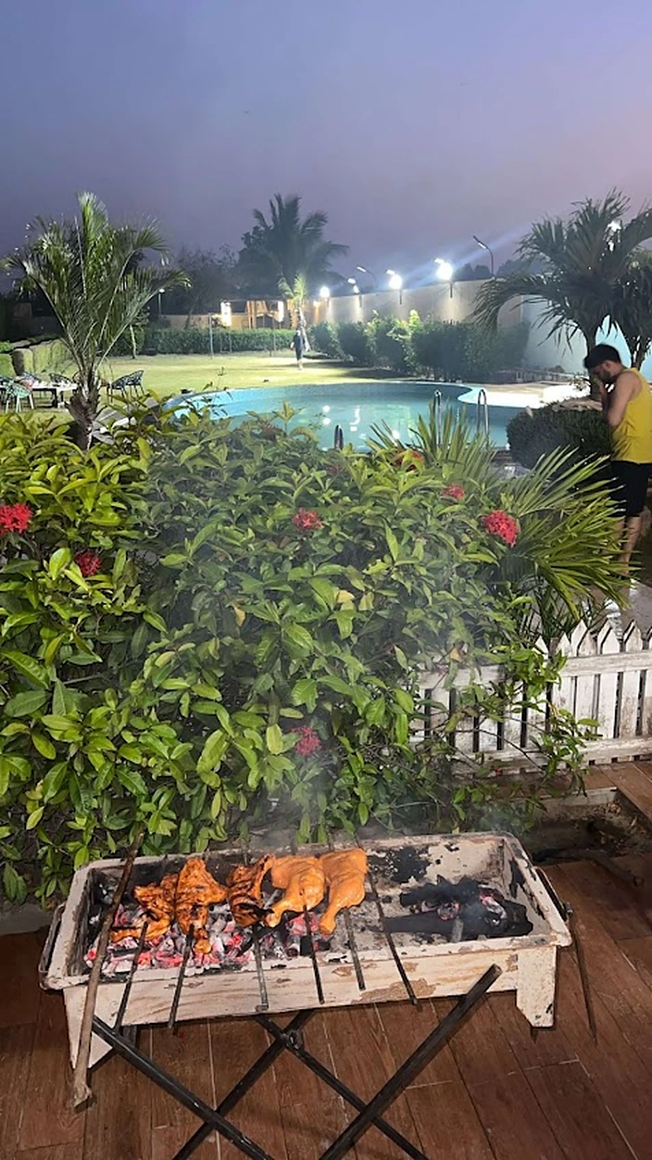 Live BBQ grill by the pool at Agha Farmhouse